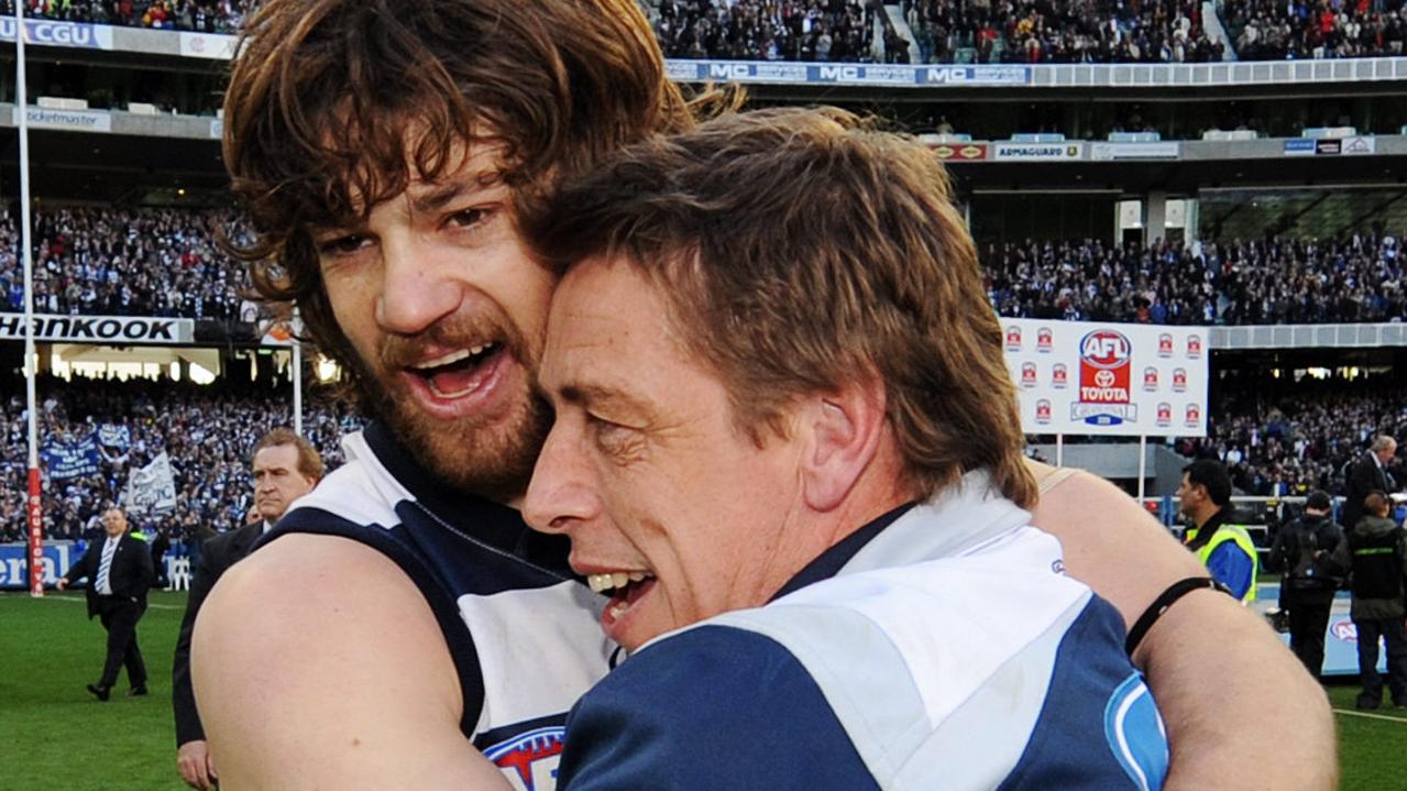 Max Rooke and coach Mark Thompson hug after the 2009 premiership win.