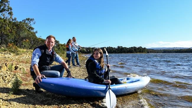 David Speirs with Laila, 13, kayaking, while Ashlee, 10, and dad Dan Waye fish at the Happy Valley Reservoir, which opens to the public on Saturday. Picture: NCA NewsWire / Morgan Sette