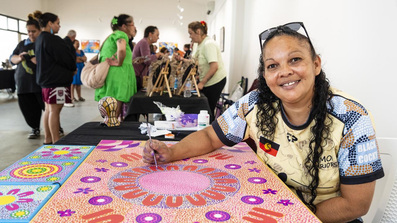 Stacey Trindall of Baru Maranga Art works on a piece of art at her stall at the Indigenous Artisan Markets at The Lighthouse, Saturday, December 17, 2022.