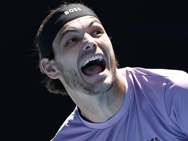 MELBOURNE, AUSTRALIA - JANUARY 16: Taylor Fritz of the United States reacts in the Men's Singles Second Round match against Cristian Garin of Chile during day five of the 2025 Australian Open at Melbourne Park on January 16, 2025 in Melbourne, Australia. (Photo by Daniel Pockett/Getty Images)