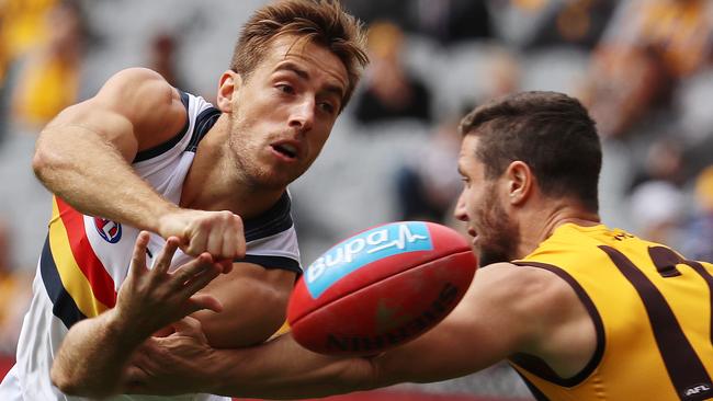 Richard Douglas gets his handball away, despite pressure from Hawthorn's James Frawley. Picture: Michael Klein