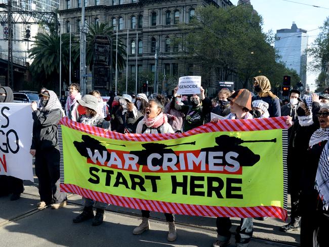 Demonstrators marching through Melbourne to protest against the Land Forces Expo. Picture: Andrew Henshaw