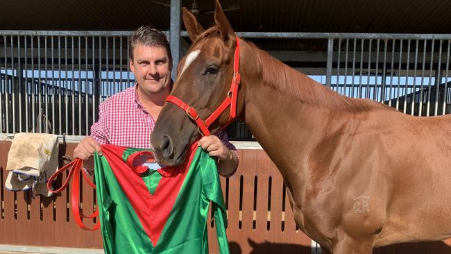 Trainer Chris Anderson shows off the new colours the jockey of Winn’em will wear on Saturday to honour Mitch Cronin.