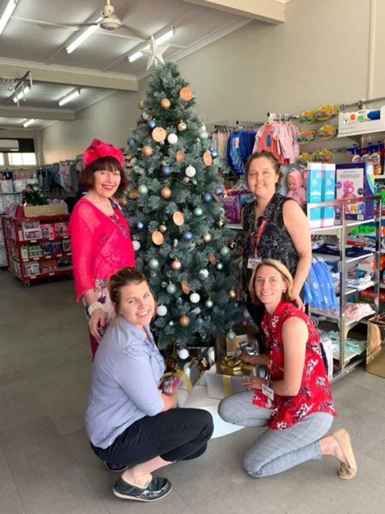 XMAS SPIRIT: Cr Kathy Duff and Graham House appeal co-ordinator Lauren Ryan with the ladies who run the Murgon Target putting the first present for the appeal under the Christmas tree.