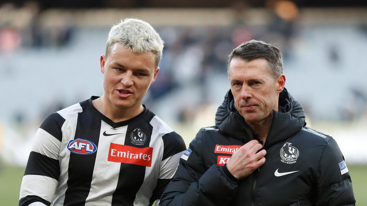 MELBOURNE, AUSTRALIA - JULY 30: Jack Ginnivan (left) and Craig McRae, Senior Coach of the Magpies look on during the 2022 AFL Round 20 match between the Collingwood Magpies and the Port Adelaide Power at the Melbourne Cricket Ground on July 30, 2022 in Melbourne, Australia. (Photo by Michael Willson/AFL Photos via Getty Images)