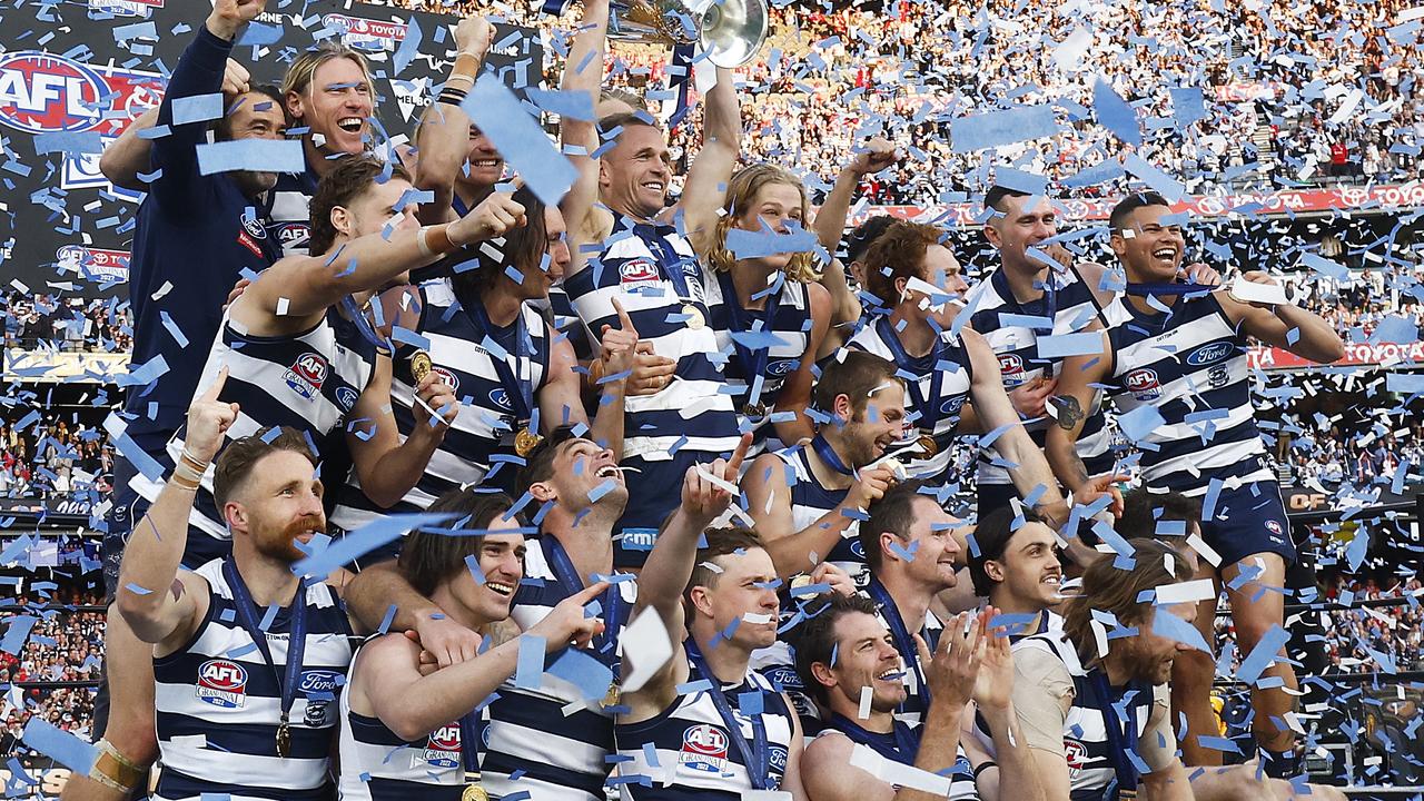 The Cats celebrate with the premiership cup. Picture: Daniel Pockett