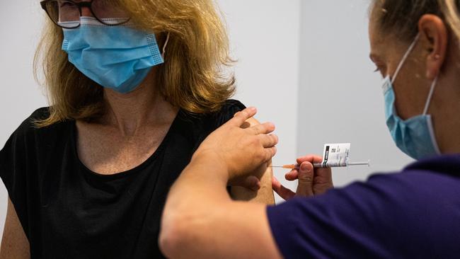 A nurse administers a COVID-19 vaccine.