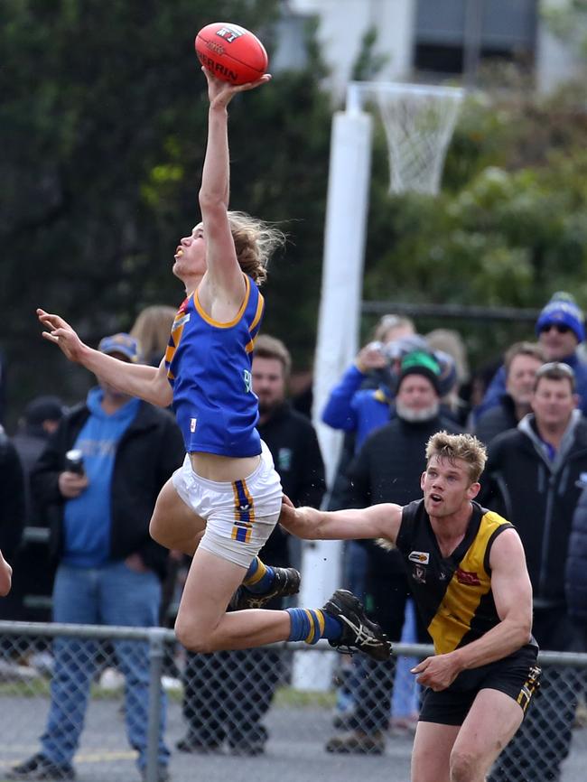 Ellison leaps for the ball playing for local side Cranbourne. Picture: Stuart Milligan