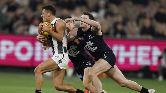 Collingwood matchwinner Nick Daicos breaks away from Carlton players during the final quarter of the Blues’ heartbreaking defeat in round 8. Picture: Michael Klein