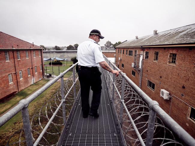 A NSW Corrective Services officer inspects rooftops at Goulburn.