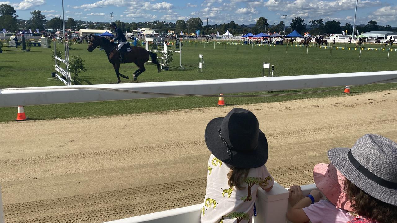 Mother and two kids watching the show jumping on the first day of the Gympie Show 2021.