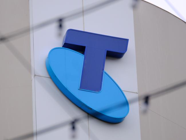 MELBOURNE, AUSTRALIA - NewsWire Photos OCTOBER 4, 2022. Generic photo people walking past the Telstra logo in Melbourne..Picture: NCA NewsWire / Luis Enrique Ascui