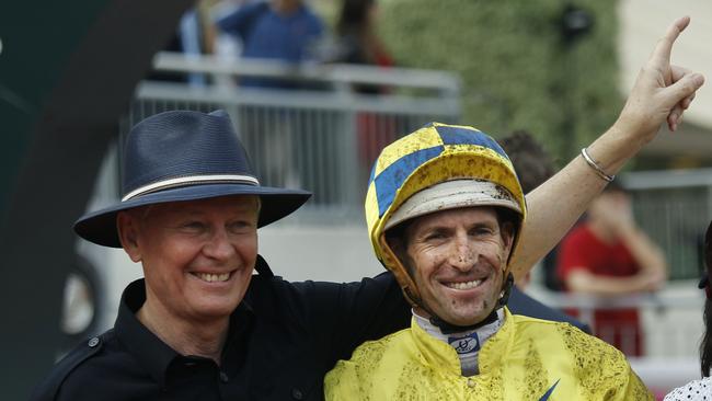 Australian jockey Hugh Bowman, right, poses with trainer John Moore. (AP Photo/Vincent Yu)