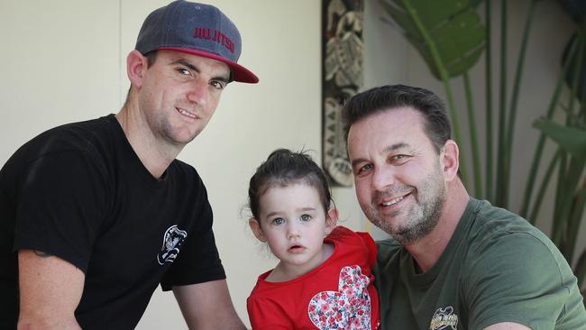 Pictured in Illawong is Joel Chapman with his brother in law Michael Zirps and Michaels daughter Ella.Joel and Michael performed CPR on Ella after she fell in their backyard pool as a toddler.Picture: Richard Dobson