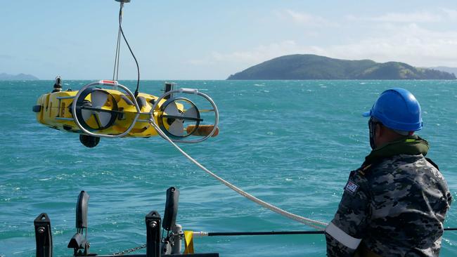 Royal Australian Navy sailors from HMAS Huon conduct search operations in the vicinity of Lindeman Island.