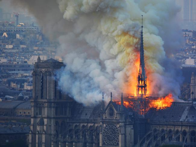 Smoke and flames rise during a fire at the landmark Notre-Dame Cathedral in central Paris on April 15, 2019, potentially involving renovation works being carried out at the site, the fire service said. (Photo by Hubert Hitier / AFP)