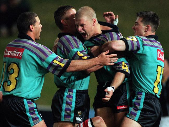 Chargers centre (centre) Jason Nichol celebrates scoring a try against Illawarra in 1997.