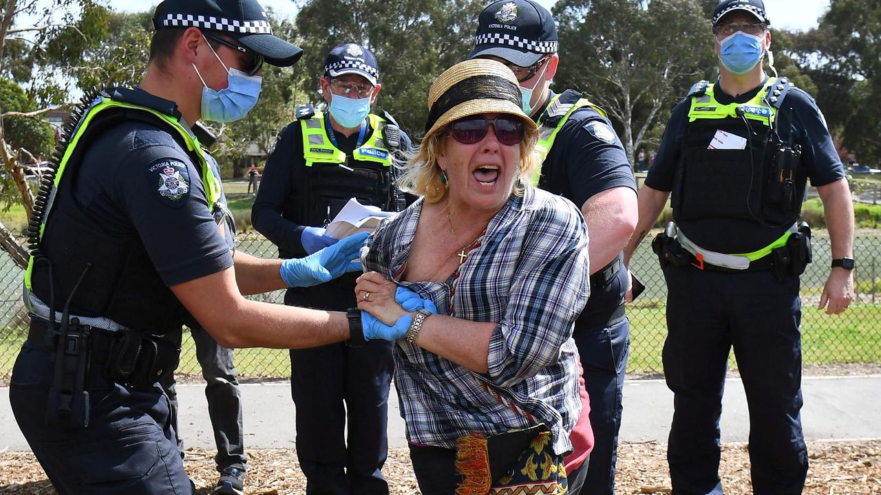 Police detain an anti-lockdown protester in the Melbourne suburb of Elsternwick. Picture: William West/AFP