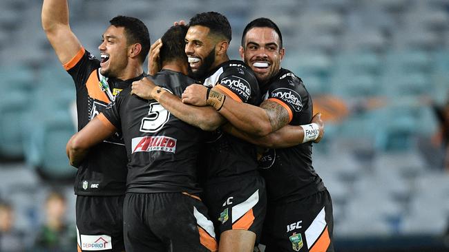 The Tigers celebrate scoring a try.