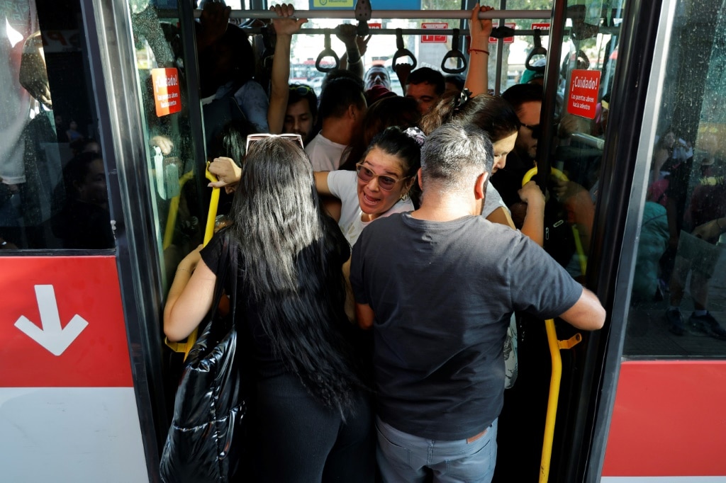 People crowd inside a bus during a Chile's worst blackout in well over a decade