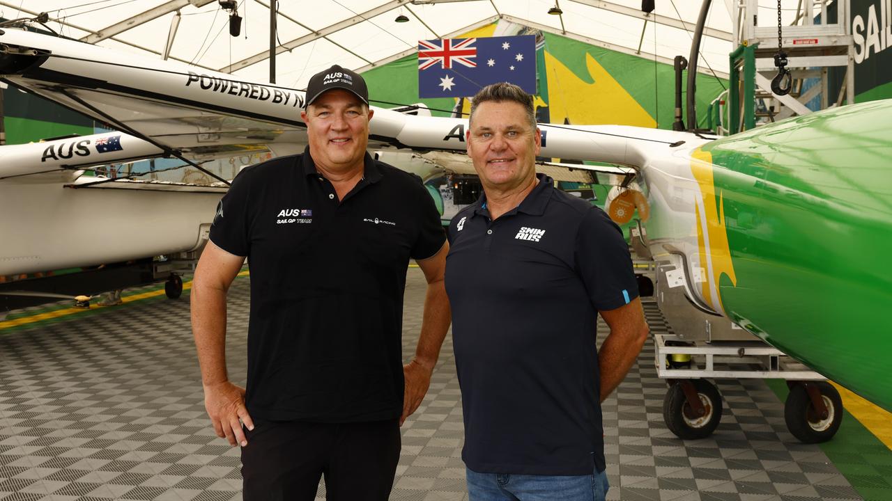 Swimming Australia's head coach Rohan Taylor (right) and Australian SailGP coach Ben Durham with their boat at their base in Rozelle. Picture: Jonathan Ng