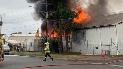 Thick black smoke billows from a fire at a business in Wingfield. Photo: 7News Adelaide.