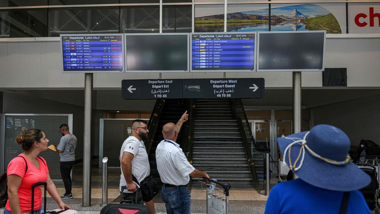 Passengers look at schedule flights screen at Rafic Hariri International Airport after their flights were delayed or cancelled in Beirut. Picture: Anwar Amro / AFP