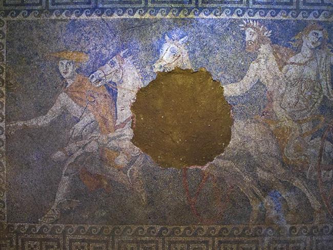 Past glories ... Inside the tomb archaeologists discovered a large, damaged mosaic floor showing the Greek god Pluto abducting the goddess Persephone on a horse-drawn chariot as the god Hermes looks on. Picture: AP