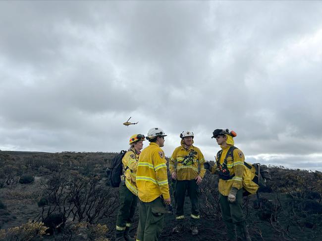 Tasmania Parks and Wildlife Service crews strategise at the Canning Peak fire. Picture: Tasmania Parks and Wildlife Service