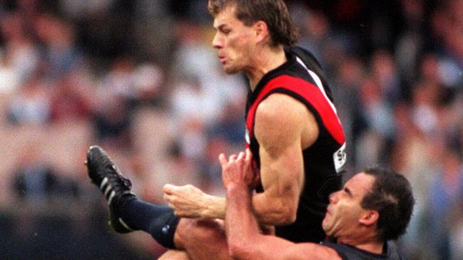 Mark Harvey meets Carlton’s Greg Williams with a bruising bump.