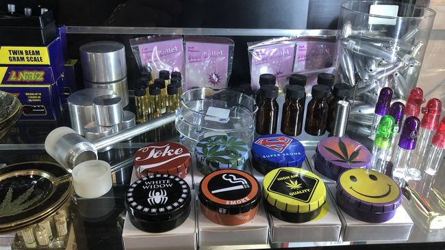 Grinders, empty vials, scales and marijuana leave emblazoned items for sale.