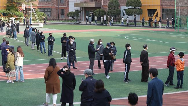 South Koreans wait in line to cast their ballots in Seoul. Picture: AFP