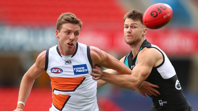 GWS’ Aidan Corr and Port Adelaide’s Robbie Gray grapple for the footy. Picture: Chris Hyde/Getty Images