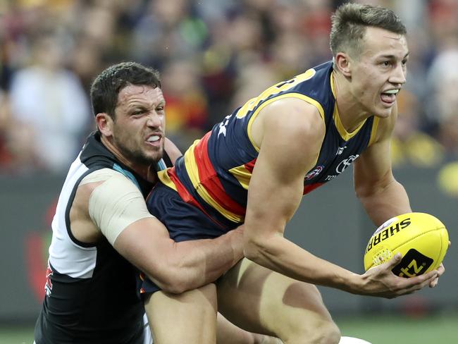 04/08/18 - AFL - Showdown 45 - Adelaide Crows v Port Adelaide at Adelaide Oval. Travis Boak tackles Tom Doedee. Picture SARAH REED