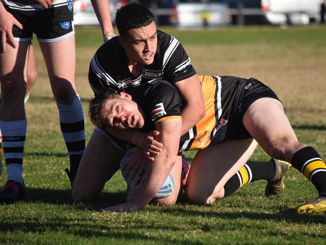 Tim Bennett is tackled by Beau-Josh Lyons. Picture: Sean Teuma/NewsLocal