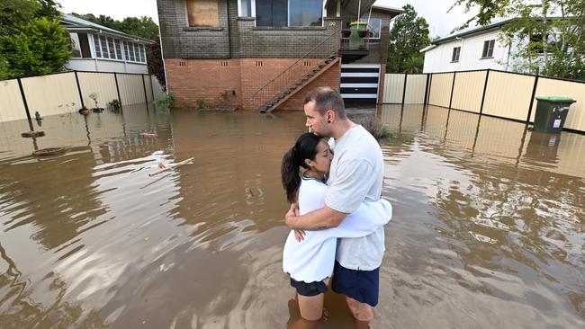 John Skudder and partner Amy Parker during the 2022 floods. Lyndon Mechielsen/The Australian