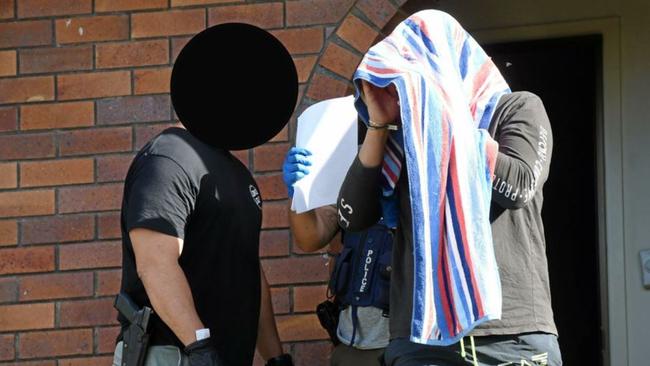 Police arrest a man after searching a house in Lismore. Picture: Marc Stapelberg.