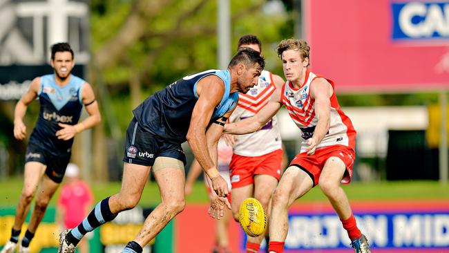 Darwin Buffaloes’ Ryan O'Sullivan tries to get to the ball ahead of Waratah rival Nicholas Gooch. Picture: MICHAEL FRANCHI