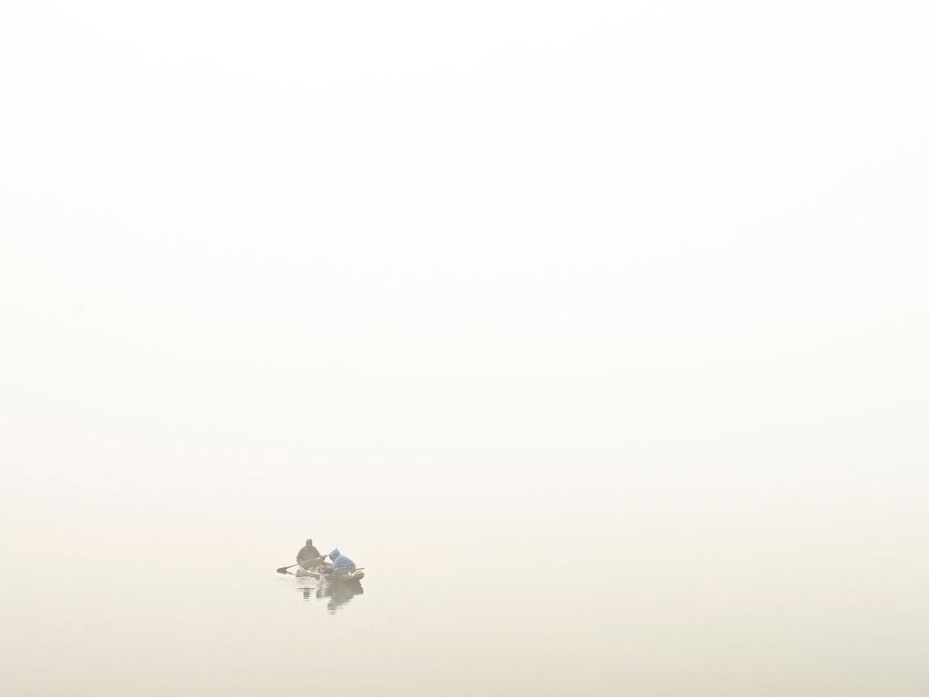 A man rows a boat amid dense fog in the Dal Lake in Srinagar, India. Picture: Tauseef Mustafa/AFP