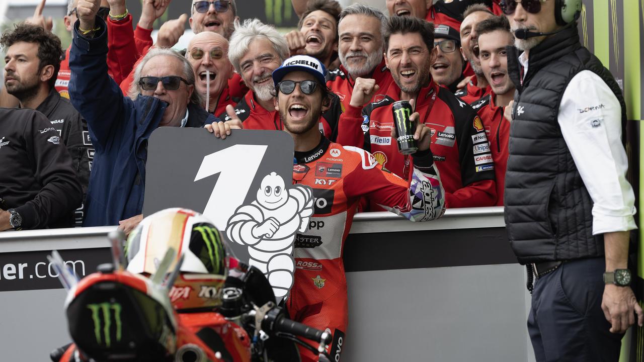 NORTHAMPTON, ENGLAND - AUGUST 04: Enea Bastianini of Italy and Ducati Lenovo Team celebrates the victory with team under the podium during the MotoGP race during the MotoGP Of Great Britain - Race at Silverstone Circuit on August 04, 2024 in Northampton, England. (Photo by Mirco Lazzari gp/Getty Images)