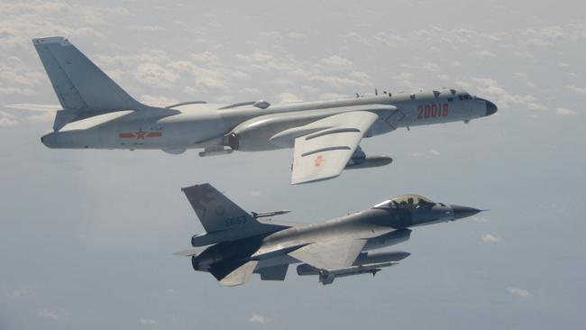 A Taiwanese F-16 fighter jet flies next to a Chinese H-6 bomber (top) off the coast of Taiwan. Picture: AFP