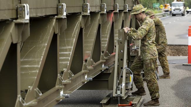 Australian Army soldiers from the 3rd Combat Engineer Regiment assemble a Medium Girder Bridge at Ollera Creek, Townsville, Queensland, during Defence Assistance to the Civil Community (DACC) following severe weather and flooding across the region. PHOTO: CPL Riley Blennerhassett