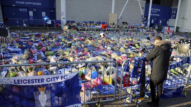 A man looks at the tributes to Vichai Srivaddhanaprabha outside Leicester City Football Club. Picture: AP