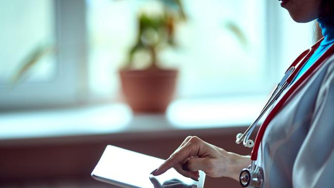 Woman doctor using tablet computer in hospital