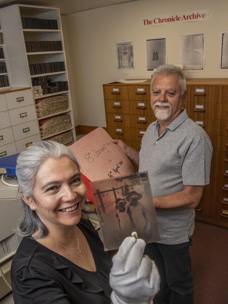 History buffs, Monica Casavieja Muniz from USQ (left) and professional historian Brian Rough (right) inspecting the Chronicle newspaper collection which contains over 1.5 million photographic negatives. archivally stored at USQ. Picture: Nev Madsen