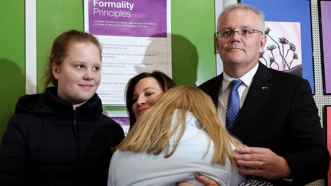 Scott Morrison and Jenny Morrison hug their children after voting at Lilli Pilli Public School in the seat of Cook on May 21, 2022 in Sydney, Australia. Picture: Asanka Ratnayake/Getty Images