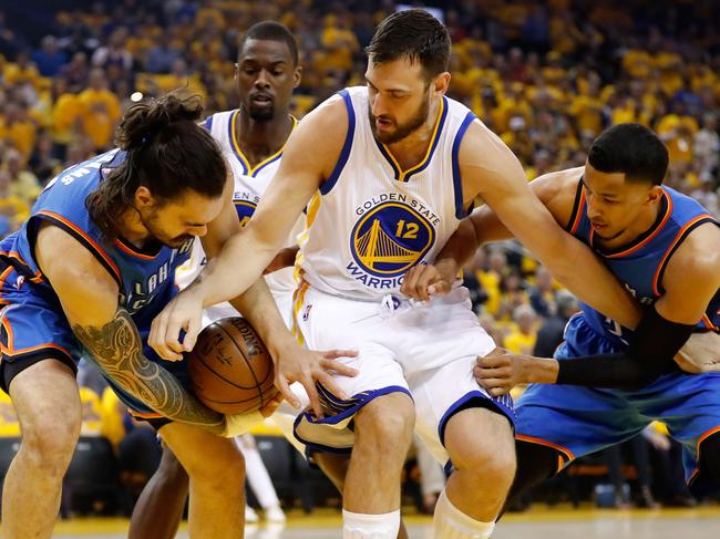 OAKLAND, CA - MAY 16: Andrew Bogut #12 of the Golden State Warriors fights for possesion of the ball with Steven Adams #12 of the Oklahoma City Thunder during game one of the NBA Western Conference Final at ORACLE Arena on May 16, 2016 in Oakland, California. NOTE TO USER: User expressly acknowledges and agrees that, by downloading and or using this photograph, User is consenting to the terms and conditions of the Getty Images License Agreement. Christian Petersen/Getty Images/AFP == FOR NEWSPAPERS, INTERNET, TELCOS & TELEVISION USE ONLY ==