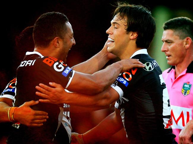 Luke Brooks, right, celebrates a try on debut for the Tigers in 2013. He has been at the club his entire career.