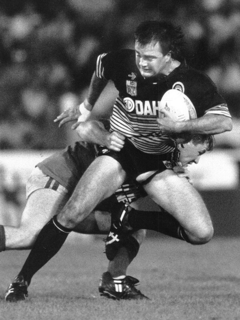 1992: Penrith rugby league player Col Bentley attempts to escape a tackle by a South Sydney player during a rugby league game