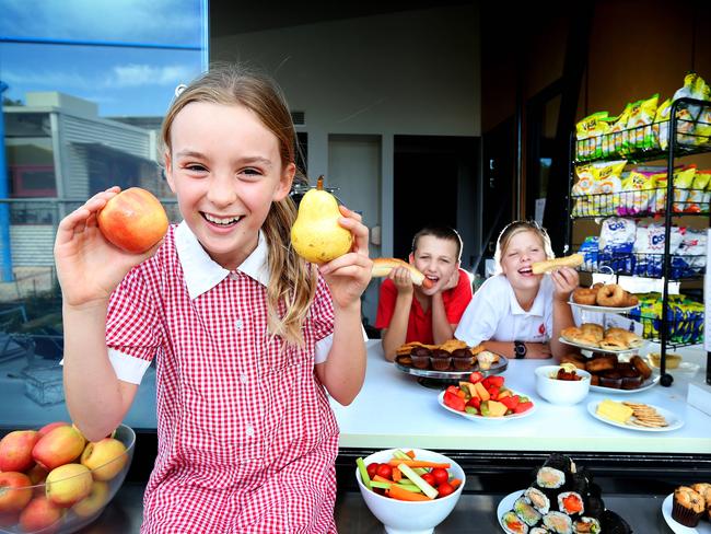 Jess, 11, Jonathan, 9, and Tess, 11, enjoy the food at their school canteen. Picture Rebecca Michael.